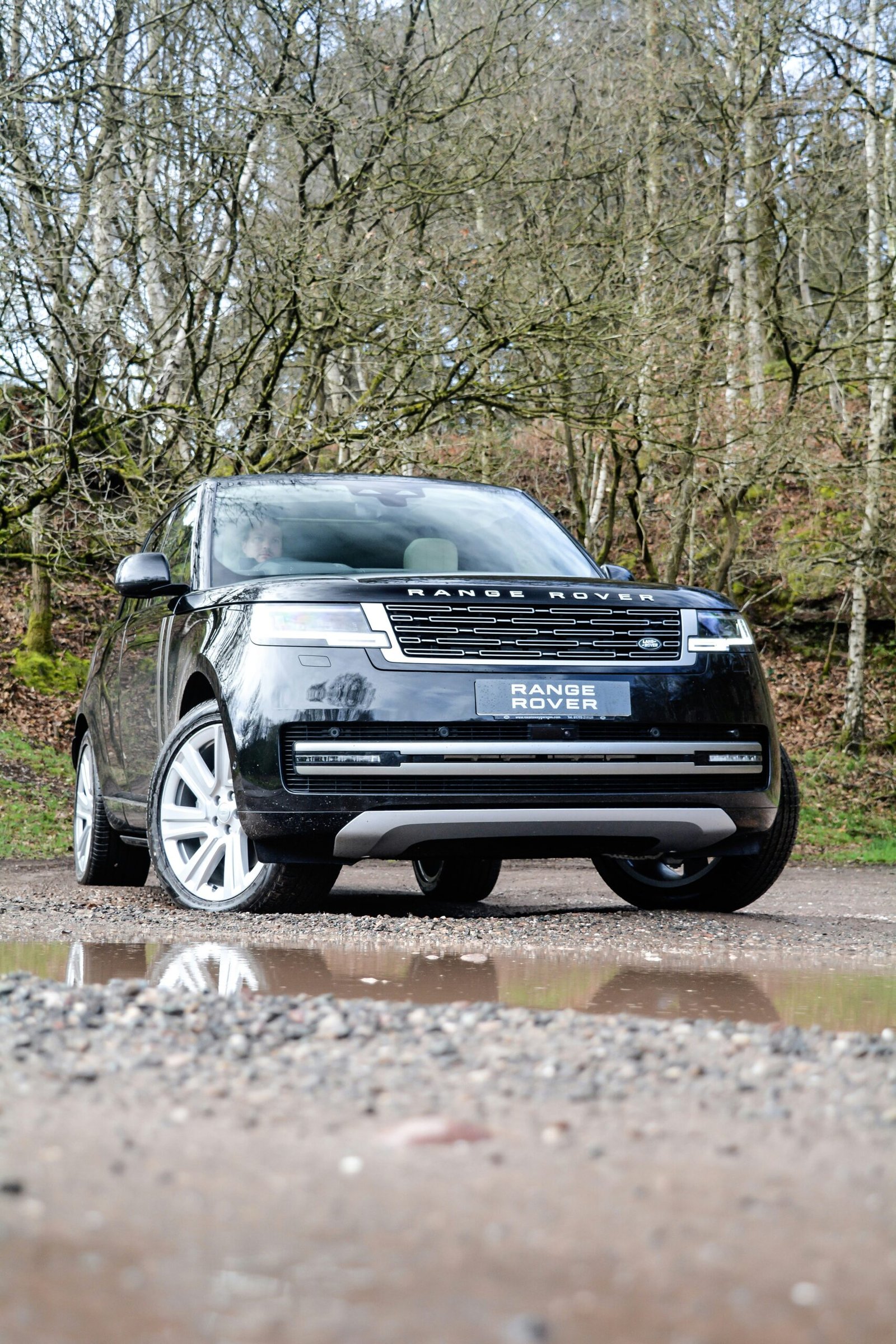 a black range rover parked on the side of a road